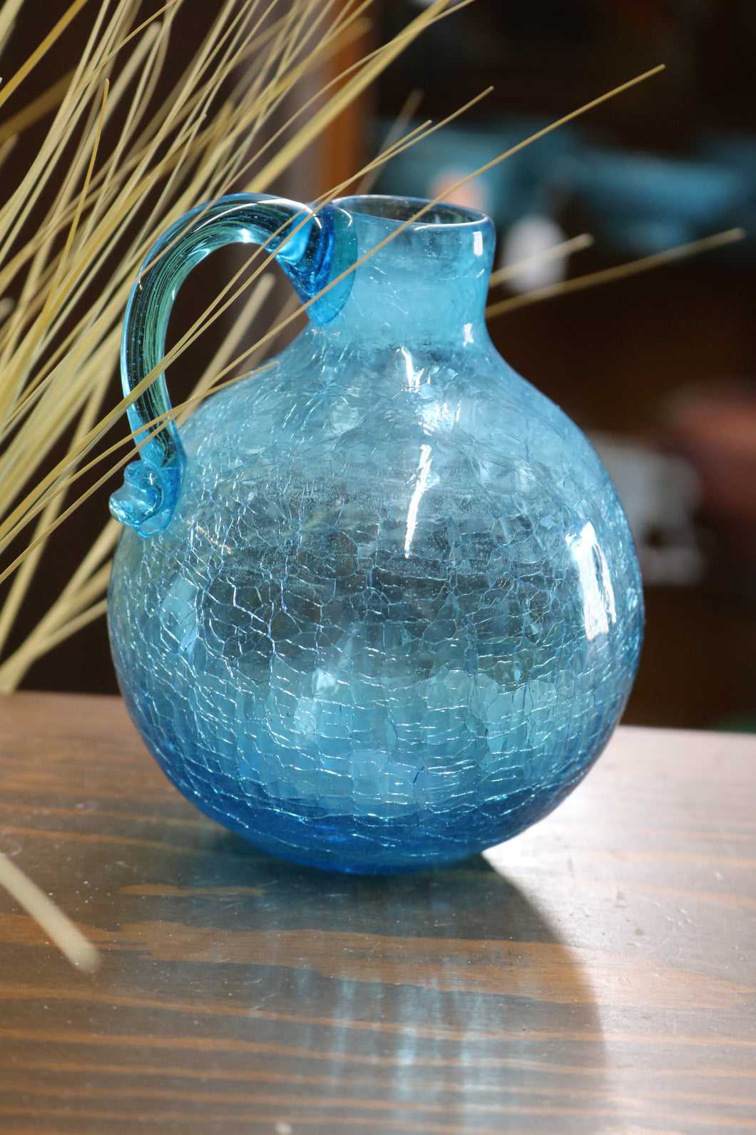 https://www.twovintagesisters.com/cdn/shop/products/Vintage-aqua-blue-5inch-crackle-glass-vase-pitcher_8_530x@2x.jpg?v=1628111552