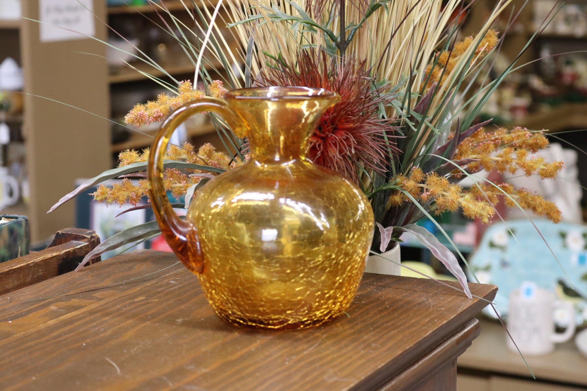 https://www.twovintagesisters.com/cdn/shop/products/Vintage-hand-blown-amber-crackle-glass-pitcher-6inch_1_1024x1024@2x.jpg?v=1630711688