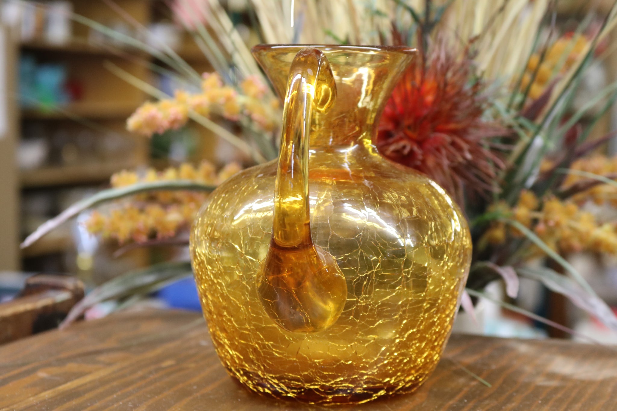 https://www.twovintagesisters.com/cdn/shop/products/Vintage-hand-blown-amber-crackle-glass-pitcher-6inch_8_1024x1024@2x.jpg?v=1630711688